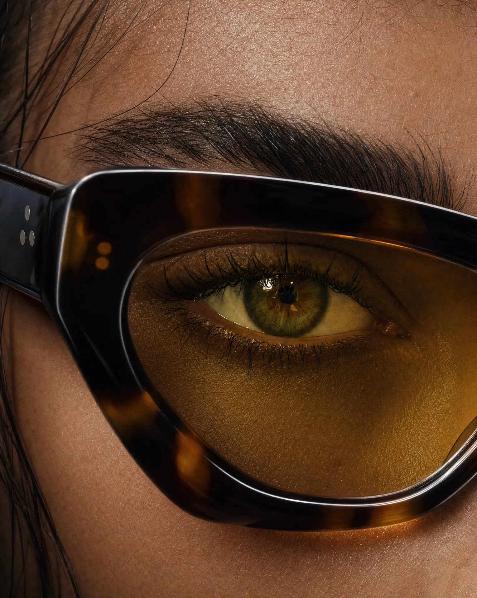 Macro close-up of an eye through tortoiseshell sunglasses